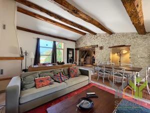 a living room with a couch and a table at Domaine Mont saint juan in Aspremont
