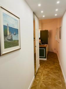 a hallway with a painting on the wall at Rab,new Apartman in Rab