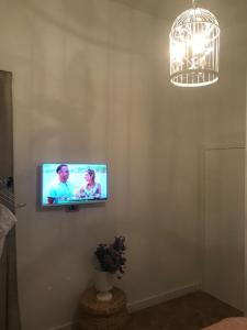 a television on a wall in a living room at Rab,new Apartman in Rab