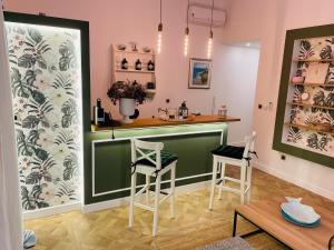 a kitchen with a green bar in a room at Rab,new Apartman in Rab