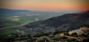 a view of a mountain with a sunset in the background at בית אירוח אישי/זוגי ומשפחתי בגליל התחתון אבטליון in Avtalyon
