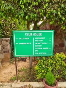a green sign in front of a building at BLOSSOM Studio in Manesar