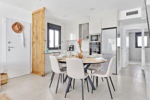 a kitchen and dining room with a table and chairs at Villa del Pinatar heated private pool in San Pedro del Pinatar