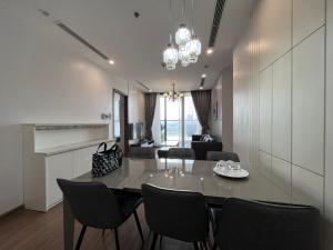 a dining room and living room with a table and chairs at Vinhomes Skylake Luxury Apartment 3 Br in Hanoi