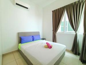 a bedroom with a bed with a pink stuffed animal on it at Pinnacle Tower Johor Bahru 3 Bed 2 Bath in Johor Bahru