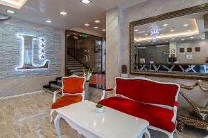 a lobby with a table and chairs and a mirror at Hotel Leipzig in Plovdiv