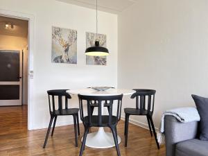 a dining room with a table and four chairs at Three Bedroom Apartment In Rdovre, Trnvej 45b, in Rødovre