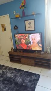 a flat screen tv sitting on a stand in a room at Betim paraíso in Betim
