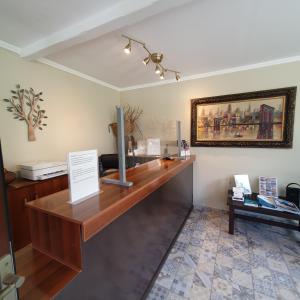 an office with a desk and a picture on the wall at Agrili Apartments & Rooms in Elia