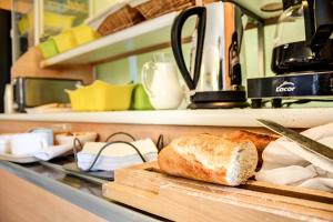 a loaf of bread on a cutting board in a kitchen at Hôtel Inn Design Issoudun in Issoudun