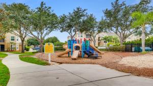 a playground with a slide in a park at 8122spd - Dream Villa In Windsor Palms in Kissimmee