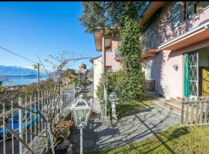 a house with a street light next to a sidewalk at Apartment With View Lake Maggiore/Laveno Mombello in Laveno