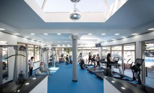 a gym with treadmills and people on machines at Danat Al Ain Resort in Al Ain