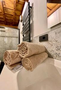 a bathroom with towels on top of a sink at La dimora della Giudecca - 11 in Cuneo
