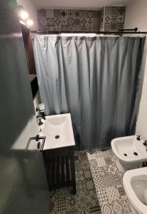 a bathroom with a sink and a toilet and a shower at Nice Full Apartment Downtown Salta in Salta