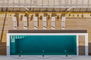 a swimming pool in front of a building at Villa da Comporta - Quarto Praia da Arrábida T0 in Comporta