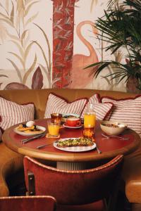 a table with plates of food and drinks on it at The Hoxton, Brussels in Brussels