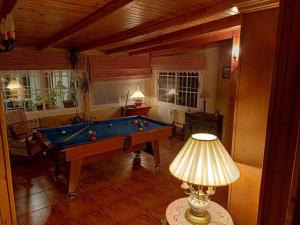 uma sala de estar com uma mesa de bilhar e um candeeiro em Mirador de Caión. Casa Rural completa con Piscina em Cayón