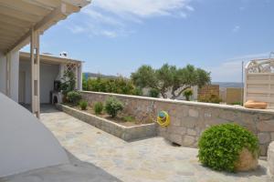 a stone retaining wall next to a house at Traditional Villa Relax in Zefiría
