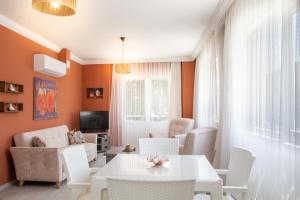 a living room with a white table and chairs at Flat w Sea View Terrace 1 min to Beach in Didim in Didim