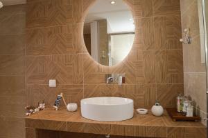 a bathroom with a white sink and a mirror at Traditional Villa Relax in Zefiría