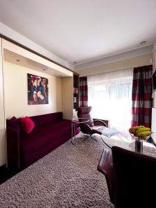 a living room with a red couch and a glass table at Apartment-Oberlaa in Vienna