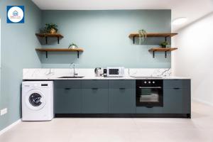 a kitchen with a sink and a dishwasher at Design apartments in Netanya in Netanya