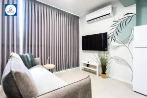 a living room with a couch and a tv at Design apartments in Netanya in Netanya