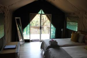 a bedroom with a large bed in a tent at Lions Rock Rapids - Lodge in Hazyview