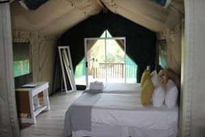 a bedroom with a large bed in a tent at Lions Rock Rapids - Lodge in Hazyview