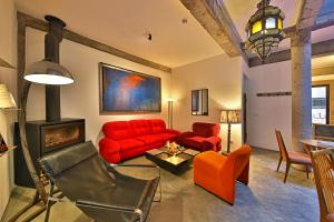 a living room with a red couch and a fireplace at Riad EspritBleu in Essaouira