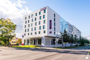 a white building on the corner of a street at Premier Inn Stuttgart Feuerbach in Stuttgart