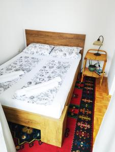 a bedroom with a bed and a table with a lamp at Apartman Amigo-Free public parking in Sarajevo