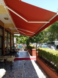 a red umbrella on a patio of a restaurant at Hotel Yildirimoglu in Alanya