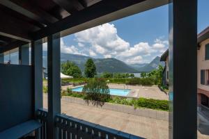 a view from the balcony of a house with a swimming pool at "Boho Oase" with lake view and pool in Därligen