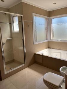 a bathroom with a tub and a shower and a toilet at Alto San Andres in San Andres de las Sierras