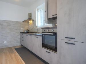 a kitchen with a stove and a sink at PALMA RESIDENCE - Villino LA ROVERE in Marco Simone