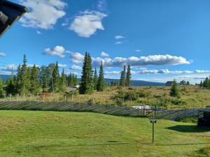 a fence in the middle of a field at A cozy shelter in beautifull nature in Tisleidalen