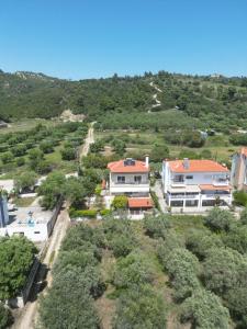 an aerial view of a house with a hill at Herodicus villa in Nea Skioni