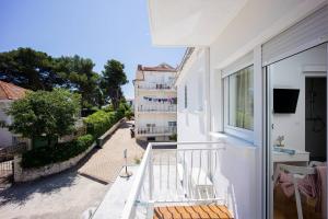 a balcony of a building with a view of a street at Apartments Batista in Trogir