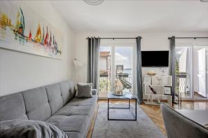 a living room with a couch and a tv at Apartments Batista in Trogir