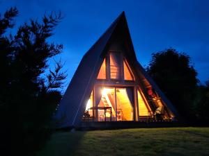 a frame house with a thatched roof at night at LOGIS LAS CROZAS La Cocotte in Vernines +48 photos
