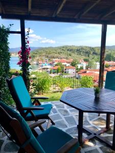 a patio with chairs and a table and a view at Seaside escape in Ormos Panagias