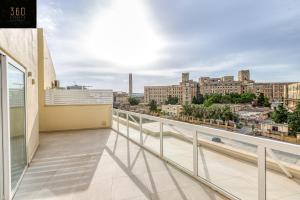 a balcony with a view of a city at Stunning 2BR penthouse with beautiful harbour view BY 360 Estates in Tal-Pietà