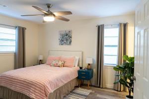 um quarto com uma cama e uma ventoinha de tecto em Madrona's Cottage- Fully fenced and pet friendly em Charleston