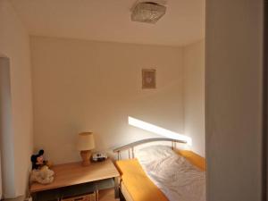 a bedroom with a bed with a light on it at Gemütliche kleine Wohnung in Korbach