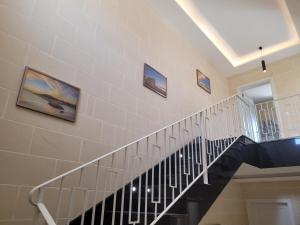 a staircase in a house with pictures on the wall at Azure W B&B in San Lawrenz