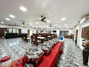 a banquet hall with a table with pots and pans at Pet Friendly Cottage Room in Kolkata in Kolkata