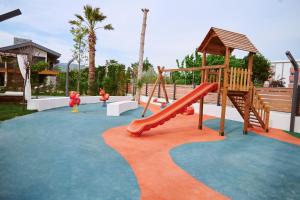 a park with a playground with a slide at Parmos Otel in Erdek