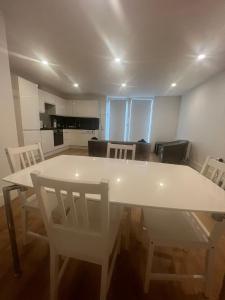 a white dining room table and chairs in a room at SW - Four - 3 in London